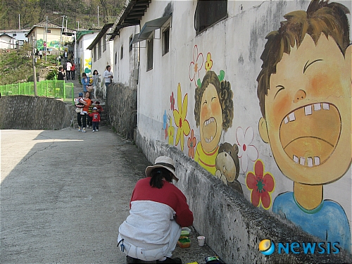 【청주=뉴시스】박세웅 기자 = 충북 청주시가 인기리에 방영됐던 드라마 '카인과 아벨'의 주 촬영지인 수암골에 대해 벽화를 새단장하고 있는 가운데 청주민예총 관계자가 벽에 그림을 그리고 있다. <관련기사 있음> swpark@newsis.com