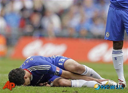 FILE - In this Saturday May 15, 2010 file photo Chelsea's Michael Ballack lays on the field injured during the FA Cup final soccer match between Portsmouth and Chelsea at Wembley Stadium in London. Germany captain Michael Ballack will miss the World Cup because of a right ankle injury. The German federation did not give any details in a short text message to journalists. Ballack flew to Germany late Sunday to have a scan on his injured right ankle. The 33-year-old Chelsea midfielder was injured in Saturday's FA Cup final win over Portsmouth. (AP Photo/Matt Dunham, File) **NO INTERNET/MOBILE USAGE WITHOUT FOOTBALL ASSOCIATION PREMIER LEAGUE (FAPL) LICENCE. CALL +44 (0) 20 7864 9121 or EMAIL info@football-datco.com FOR DETAILS