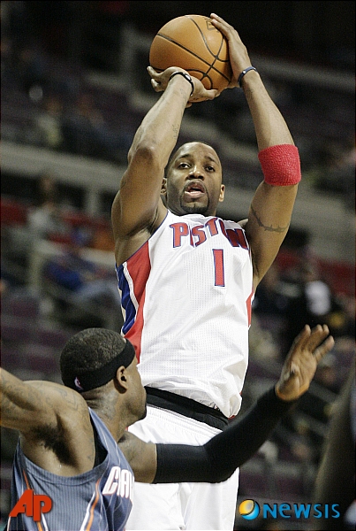 Detroit Pistons' Tracy McGrady (1) takes a shot over Charlotte Bobcats' Stephen Jackson in the second half of an NBA basketball game Wednesday, Feb. 2, 2011, in Auburn Hills, Mich. The Bobcats defeated the Pistons 97-87. (AP Photo/Duane Burleson)