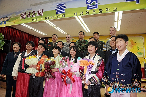 【파주=뉴시스】사진공동취재단 = 16일 경기도 파주시 대성동초등학교 졸업식에서 한복을 입은 졸업생들이 내빈들과 기념촬영을 하고 있다.&nbsp; photo@newsis.com