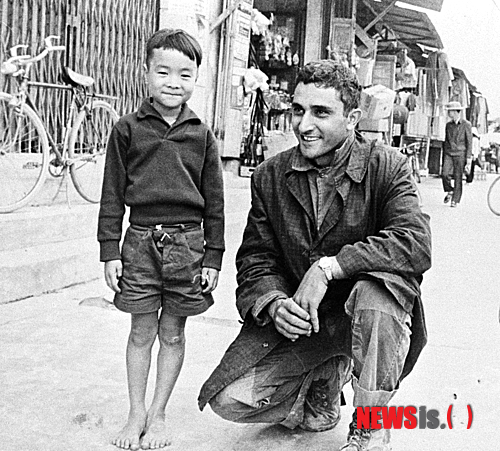 2일 타계한 조지 에스퍼 전 AP통신 사이공지국장이 1966년 1월 베트남 중부 꽝응아이에서 만난 어린이와 사진기 앞에서 자세를 취하고 있다. (AP 자료사진/뉴시스)