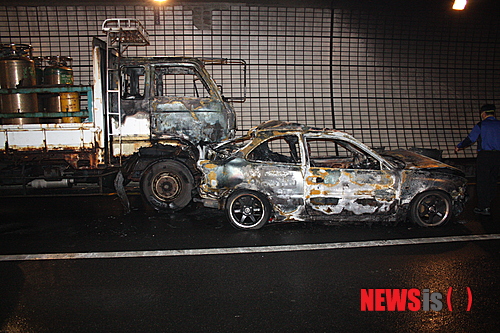 【부산=뉴시스】하경민 기자 = 28일 오후 2시 19분께 부산 남구 황령터널 안에서 전포동 방면으로 달리던 2.5t 트럭이 앞서가던 액센트 승용차를 추돌해 뒤따르던 차량 7대가 잇따라 추돌했다. 이 사고로 액센트 승용차가 전소하고, 트럭의 절반 정도 태운 뒤 출동한 소방대원들에 의해 20여 분 만에 진화됐다. 사진은 전소한 액센트 승용차와 반소한 트럭. (사진=부산경찰청 제공)&nbsp; photo@newsis.com