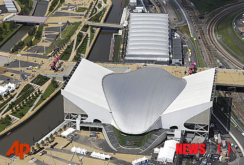 An aerial view of the London 2012 Olympics summer games Aquatic centre, bottom, and the Water Polo pool in the Olympic Park, Friday, July 13, 2012. The games begin July 27 in London. (AP Photo/Alastair Grant)