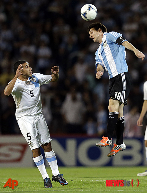 【멘도사(우루과이)=AP/뉴시스】아르헨티나의 '축구천재' 리오넬 메시(27·FC바르셀로나)가 지난 2012년 10월13일(한국시간) 우루과이의 멘도사에서 열린 2014브라질월드컵 남미 최종예선 8차전에서 헤딩을 하고 있다.&nbsp; 우루과이의 왈테르 가르가노(30·파르마FC)의 공포에 질린 모습이 인상적이다.&nbsp; 이날 아르헨티나는 메시의 멀티골에 힘입어 3-0 완승을 거뒀다.