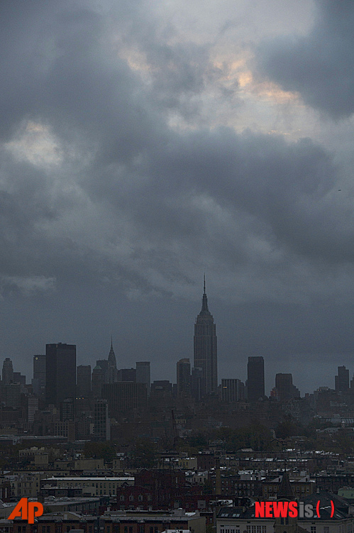 【뉴욕=AP/뉴시스】허리케인 샌디가 뉴저지주 해변에 29일 밤 8시에 도착한 후 10시간 정도가 지난 30일 새벽 뉴욕 맨하탄의 엠파이어 스테이트 빌딩 등이 불 꺼진 채 날을 맞고 있다. 이 무렵 샌디는 펜실베이니아를 거쳐 다시 동쪽으로 꺽어 뉴욕주 서쪽 가장자리로 올라가고 있다.&nbsp;&nbsp; 