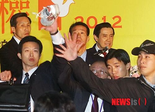 【서울=뉴시스】 10일(현지시간) 마잉주(馬英九) 대만 총통이 신베이(新北)시에서 열린 세계 인권의 날 기념행사에 참가한 가운데 마 총통의 경호원 린이민(林宜民·왼쪽에서 첫번째)이 날아오는 운동화를 막아내고 있다. 이날 신발을 던진 사람은 천수이볜(陳水扁) 전 총통 지지자로 그의 석방을 요구하며 이 같은 행동을 한 것로 알려졌다. (사진출처: 하이샤다오바오(海峽導報))