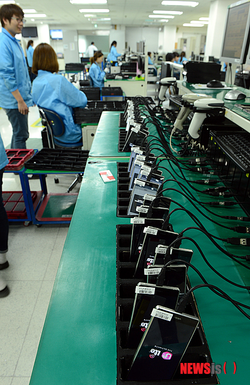 【김포=뉴시스】박상훈 기자 = 16일 오후 팬택 김포 공장에서 직원들이 거의 완성된 휴대폰에 데이터를 전송, 관리하고 있다.&nbsp; hyalinee@newsis.com