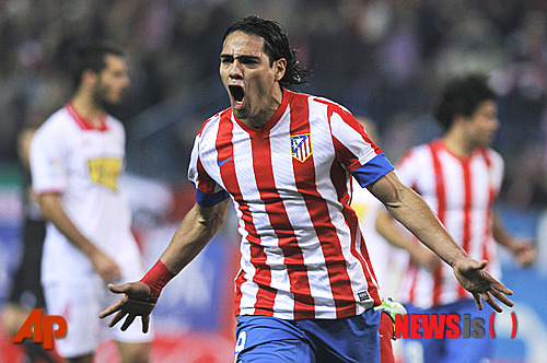 FILE.- In this Nov. 25, 2012 file photo Atletico de Madrid's Radamel Falcao from Colombia celebrates his goal during a Spanish La Liga soccer match against Sevilla at the Vicente Calderon stadium in Madrid, Spain. Monaco says it has reached an agreement with Atletico Madrid to sign Colombia striker Radamel Falcao on a five-year deal. The club announced the agreement on its website Friday May 31, 2013. (AP Photo/Andres Kudacki, FILE)