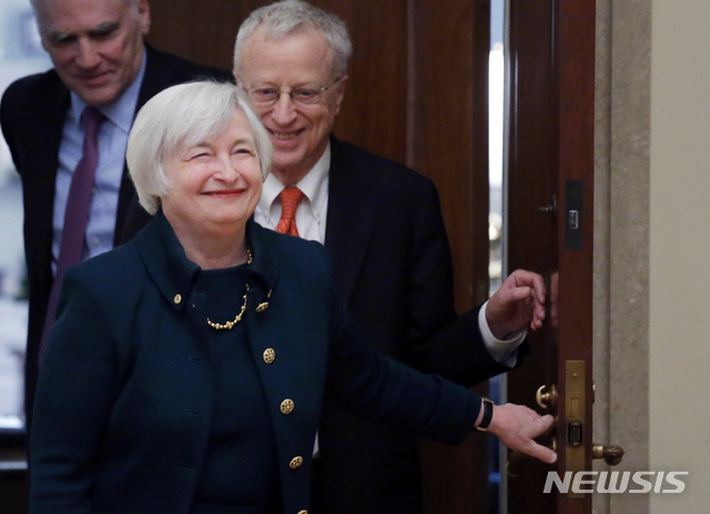 [워싱턴=AP/뉴시스] 2014년 2월3일(현지시간) 재닛 옐런 당시 연방준비제도(Fed·연준) 의장이 취임선서를 하려고 입장하고 있다. 2001년 노벨 경제학상 수상자이자 옐런의 남편인 조지 애컬로프가 웃으며 뒤따르고 있다. 2020.11.25. 
