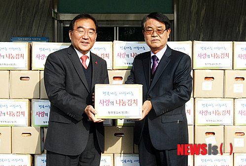 【청주=뉴시스】이병찬 기자 = 3일 충북 청주시청사 앞에서 청주청과㈜ 양승인(오른쪽) 대표가 이승훈 청주시장에게 김장김치 500상자를 기탁하고 있다.2014.12.03.(사진=청주시 제공)&nbsp; photo@newsis.com