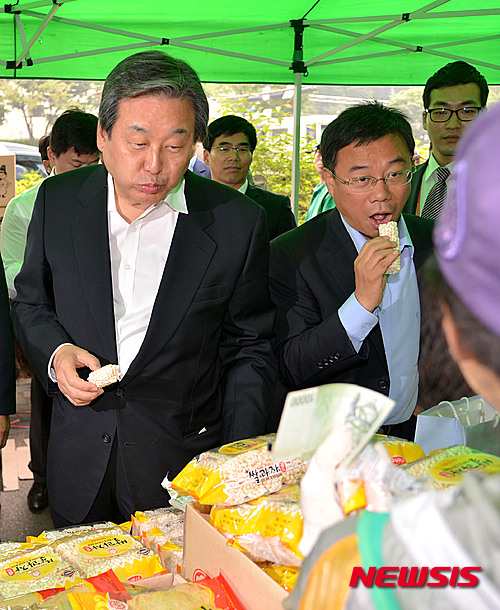 【성남=뉴시스】박동욱 기자 = 4·29 재보궐 선거 감사 인사에 나선 새누리당 김무성 대표와 성남 중원에서 당선된 신상진 의원이 15일 오전 경기도 성남 상대원1동주민센터 앞에서 열린 바자회를 방문해 쌀과자를 먹으며 상인들과 대화를 나누고 있다. 2015.05.14.&nbsp; fufus@newsis.com