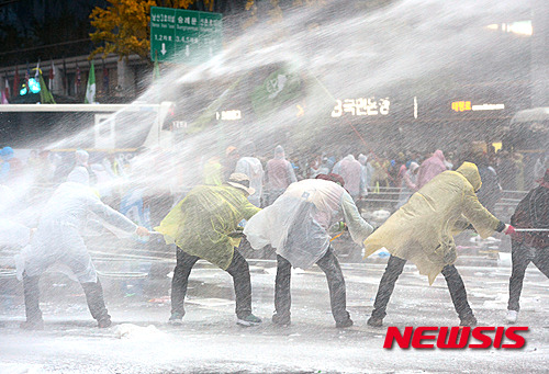 【서울=뉴시스】임태훈 기자 = 14일 오후 서울 중구 시청 서울광장에서 민중총궐기대회를 마친 참가자들이 경찰버스를 끌어내려 하자 경찰이 캡사이신을 섞은 물대포를 쏘고 있다.&nbsp; 민주노총, 전농 등 참가단체들은 집회에서 정부가 추진하는 노동개혁과 역사 교과서 국정화 정책을 규탄하고 청년실업, 쌀값 폭락, 빈민 문제 등의 해결책 마련을 요구할 예정이다. 2015.11.14.&nbsp; taehoonlim@newsis.com