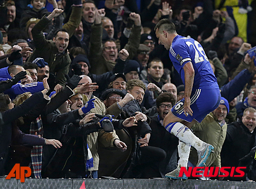 Chelsea's captain John Terry jumps into the crowd as he celebrates scoring his side's third goal to draw the game 3-3 during the English Premier League soccer match between Chelsea and Everton at Stamford Bridge stadium in London, Saturday, Jan. 16, 2016. (AP Photo/Matt Dunham)