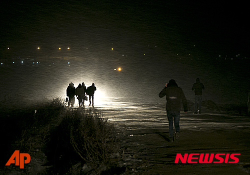【미라토바치=AP/뉴시스】난민들이 17일(현지시간) 눈보라가 치는 한 밤중에 세르비아 국경마을 미라토바치 인근을 걸어가고 있다. 혹독한 겨울추위와 눈보라에도 불구하고 세르비아에는 매일 수백명씩 새로운 난민들이 도착하고 있다. 2016.01.18 