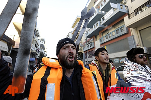 【알렉산두르폴리스=AP/뉴시스】그리스 시위대가 23일(현지시간) 북동부 터키 접경지역 알렉산드루폴리스에서 유럽 난민과의 연대를 위한 구호를 외치며 시위를 벌이고 있다. 그리스 에게 해에서 최소 46명이 숨지는 난민선 전복 사고가 발생하자 이날 그리스와 터키 간 접경지역의 통행 통제 완화를 요구하는 시위에 1000명이 참여했다. 2016.01.24