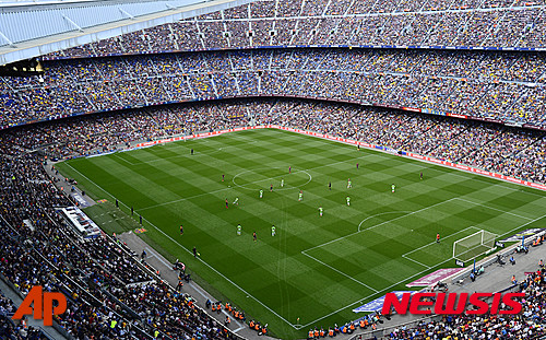 FILE- In this file photo taken on Saturday May 3, 2014, FC Barcelona play against Getafe during a Spanish La Liga soccer match at the Camp Nou stadium in Barcelona, Spain. Barcelona says the seating capacity in Camp Nou will be increased to 105,000 people and the roof will ring the entire stadium by the 2021-22 season. (AP Photo/Manu Fernandez, File)