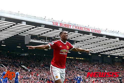 Manchester United's Anthony Martial celebrates scoring his side's first goal of the game, during the English Premier League soccer match between Manchester United and Everton, at Old Trafford, in Manchester, England, Sunday April 3, 2016. (Martin Rickett/PA via AP) UNITED KINGDOM OUT NO SALES NO ARCHIVE