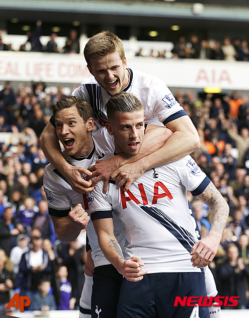 Tottenham Hotspur's Toby Alderweireld, center, celebrates scoring his side's second goal with Jan Vertonghen, left, and Eric Dier, top, during the English Premier League soccer match between Tottenham Hotspur and Manchester United at White Hart Lane stadium in London, Sunday, April 10, 2016. (AP Photo/Matt Dunham)