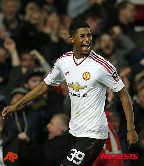 United?s Marcus Rashford celebrates after scoring his side's first goal during the English FA Cup quarterfinal replay soccer match between West Ham and Manchester United at Boleyn Ground stadium in London, Wednesday, April 13, 2016.(AP Photo/Alastair Grant)