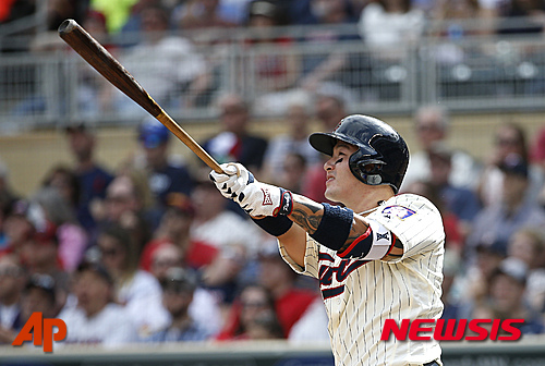 Minnesota Twins' Byung Ho Park watches the flight of his solo home run off Los Angeles Angels relief pitcher Joe Smith during the eighth inning of a baseball game in Minneapolis, Saturday, April 16, 2016. (AP Photo/Ann Heisenfelt)