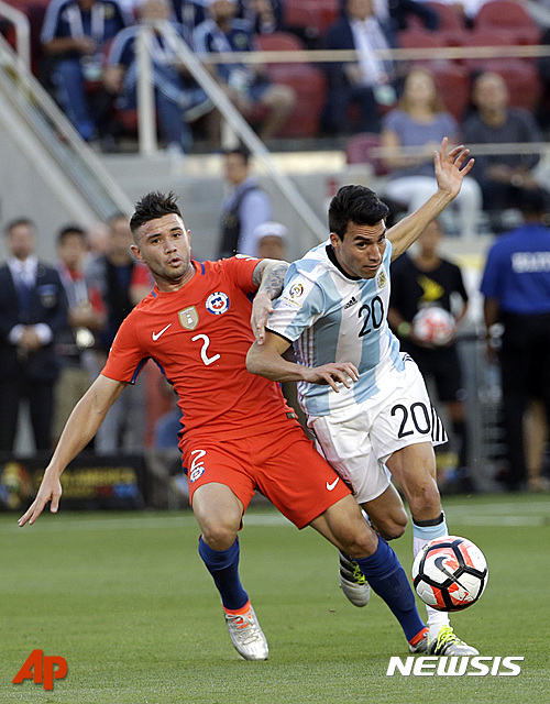 Argentina?s Nicolas Gaitan and Chile?s Eugenio Mena, left, fight for the ball during a Copa America Centenario Group A soccer match at Levi's Stadium in Santa Clara, Calif., Monday June 6, 2016. (AP Photo/Jeff Chiu)
