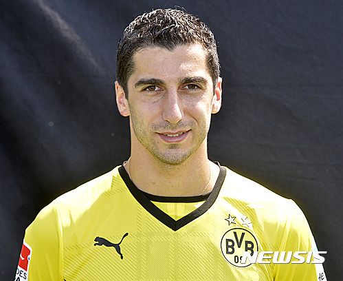 FILE - In this July 9, 2013 file picture Dortmund's player Henrikh Mkhitaryan from Armenia poses at a media event of Borussia Dortmund in Dortmund, Germany,&nbsp; Borussia Dortmund says Saturday July 2, 2016 midfielder Henrikh Mkhitaryan is joining Manchester United, becoming Jose Mourinho's third signing as manager. The 27-year-old Armenia international has been sold to the 20-time English champions as he had only one year remaining on his Dortmund contract. (AP Photo/Martin Meissner,file)