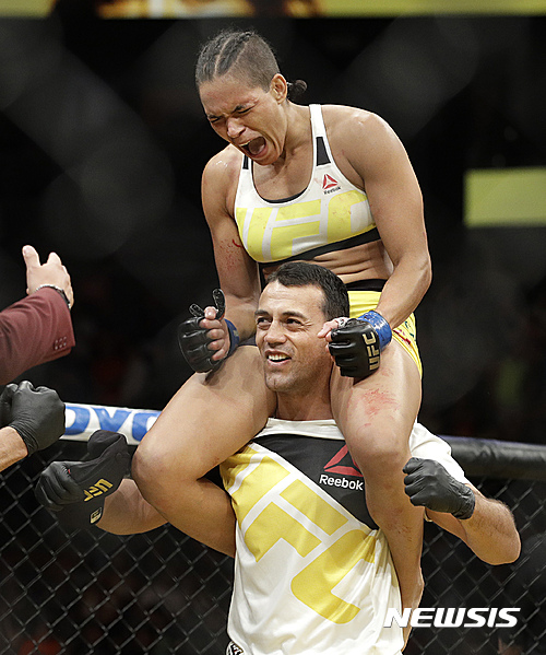 Amanda Nunes celebrates after defeating Miesha Tate during their women's bantamweight championship mixed martial arts bout at UFC 200, Saturday, July 9, 2016, in Las Vegas. (AP Photo/John Locher)