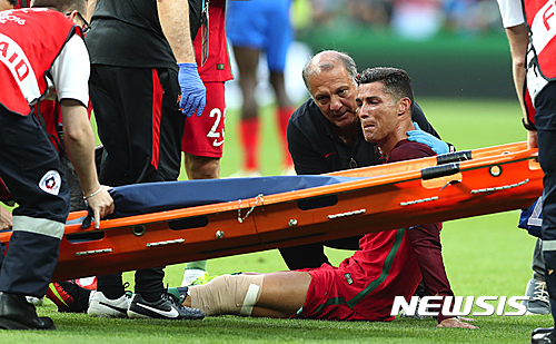 Portugal's Cristiano Ronaldo cries on the pitch during the Euro 2016 final soccer match between Portugal and France at the Stade de France in Saint-Denis, north of Paris, Sunday, July 10, 2016. (AP Photo/Thanassis Stavrakis)