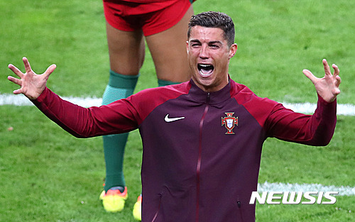 Portugal's Cristiano Ronaldo celebrates after his team won the Euro 2016 final soccer match between Portugal and France at the Stade de France in Saint-Denis, north of Paris, Sunday, July 10, 2016. (AP Photo/Thibault Camus)