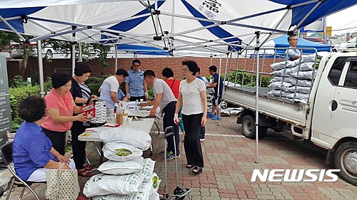 【괴산=뉴시스】김재광 기자 = 6일 괴산군 명품농산물인 대학찰옥수수가 첫 출하됐다. 사진은 지난해 청안면 주민자치위원회가 서울시 중랑구 면목4동 주민센터에서 대학찰옥수수 직거래 행사를 개최한 모습.2017.07.06.(사진=괴산군청 제공)photo@newsis.com