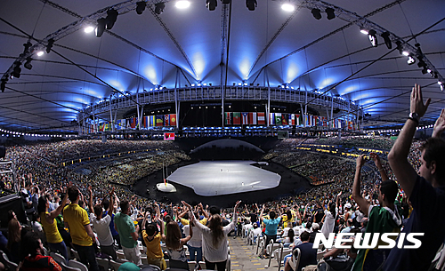 Audience participate in in a rehearsal before the opening ceremony for the 2016 Summer Olympics in Rio de Janeiro, Brazil, Friday, Aug. 5, 2016. (AP Photo/Charlie Riedel)