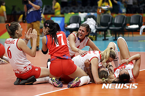 Members of Serbia's team celebrate a win after a women's semifinal volleyball match against the United States at the 2016 Summer Olympics in Rio de Janeiro, Brazil, Thursday, Aug. 18, 2016. (AP Photo/Matt Rourke)