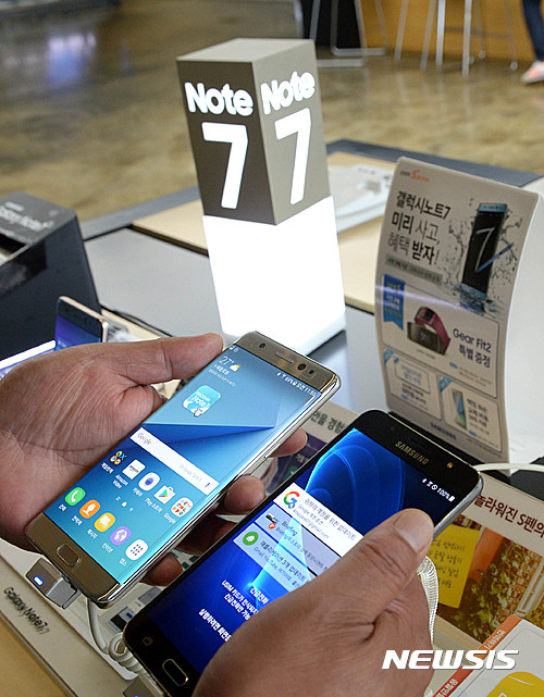 【서울=뉴시스】박주성 기자 = 삼성전자가 폭발 논란이 제기된 갤럭시노트7의 전량 리콜을 검토 중인 가운데 2일 서울 광화문 KT 스퀘어에서 한 시민이 갤럭시노트7과 다른 모델의 삼성 핸드폰을 비교해 보고 있다. 2016.09.02.&nbsp;&nbsp; park7691@newsis.com