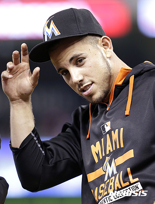 FILE - In this Monday, June 1, 2015, file photo, Miami Marlins pitcher Jose Fernandez replaces his cap after the singing of the national anthem before the start of a baseball game between the Miami Marlins and the Chicago Cubs, in Miami. The Marlins announced Sunday, Sept. 25, 2016, that ace right-hander Fernandez has died. The U.S. Coast Guard says Fernandez was one of three people killed in a boat crash off Miami Beach early Sunday. (AP Photo/Wilfredo Lee, File)