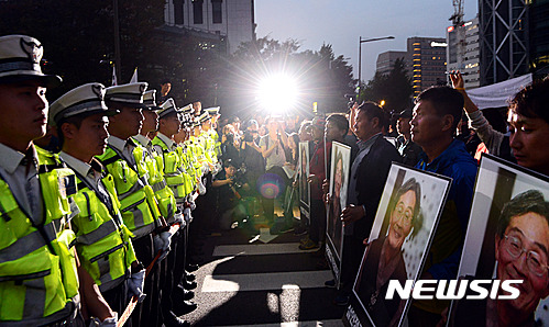 【서울=뉴시스】권현구 기자 = 1일 오후 서울 종로구 대학로에서 열린 '백남기 농민 추모대회' 참가자들이 백남기 농민이 쓰러진 종로1가를 향해 행진하다 경찰병력에 가로막혀 대치하고 있다. 2016.10.01. stoweon@newsis.com