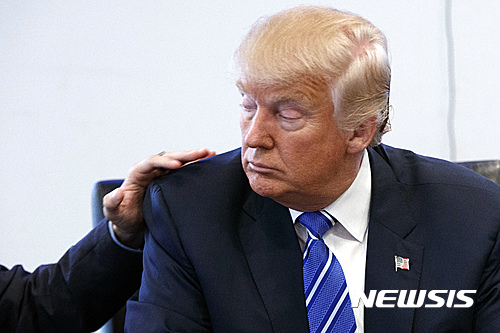 Art Del Cueto, a vice president for the National Border Patrol Council, puts his hand on the shoulder of Republican presidential candidate Donald Trump during a meeting at Trump Tower, Friday, Oct. 7, 2016, in New York. (AP Photo/ Evan Vucci)