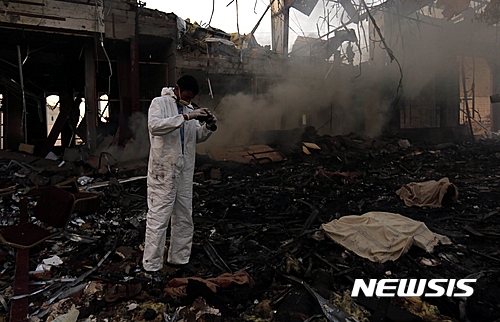 【사나(예멘)=AP/뉴시스】 8일(현지시간) 사우디 연합군의 공습으로 폐허가 된 장례식장에서 한 남자가 현장 사진을 찍고 있다. 2016.10.10&nbsp;&nbsp; 
