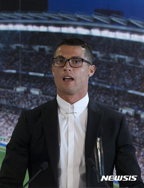 Real Madrid's Cristiano Ronaldo speaks after signing a new contract at the Santiago Bernabeu stadium in Madrid, Spain, Monday, Nov. 7, 2016. Real Madrid have extend Ronaldo's contract until June 2021, when the three-time world player of the year will be 36. Financial details were not released, although the star forward is expected to remain the team's top-paid player. (AP Photo/Paul White)