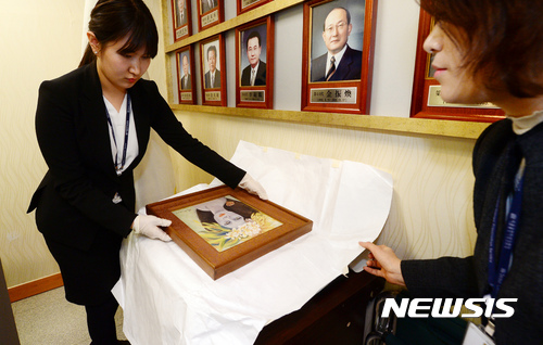 【서울=뉴시스】이영환 기자 = 19일 오후 서울 서초구 서울중앙지방검찰청 소회의실에서 열린 고 천경자 화백 '미인도' 위작 논란 사건 수사결과 브리핑에서 검찰 관계자가 미인도 원본을 공개하고 있다. 검찰은 25년간 위작 논란이 일었던 천 화백의 미인도가 진품이라는 결론을 내렸다. 2016.12.19.&nbsp; photo@newsis.com