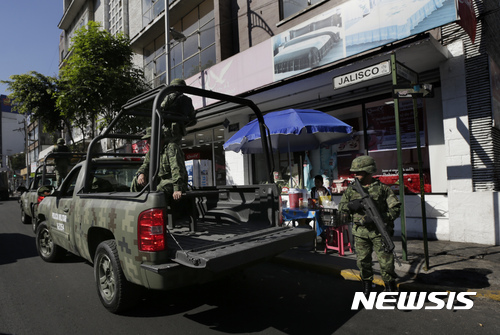 【멕시코시티 = AP/뉴시스】 = 멕시코의 휘발유 폭동 항의 시위대가 일부 약탈 및 폭력사태를 빚게 되자 5일(현지시간) 전투경찰대의 트럭이 멕시코시티 중심가의 은행 앞에 배치되어 경비를 하고 있다. 경찰은 지금까지 소요사태로 경찰관 1명이 차에 치여 숨졌고 5명이 부상당했으며 300여개의 상점이 약탈당해 600명 이상이 체포되었다고 말했다.    