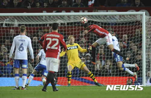 Manchester United's Chris Smalling, right, scores during the English FA Cup Fourth Round soccer match between Manchester United and Wigan Athletic at Old Trafford in Manchester, England, Sunday, Jan. 29, 2017. (AP Photo/Rui Vieira)