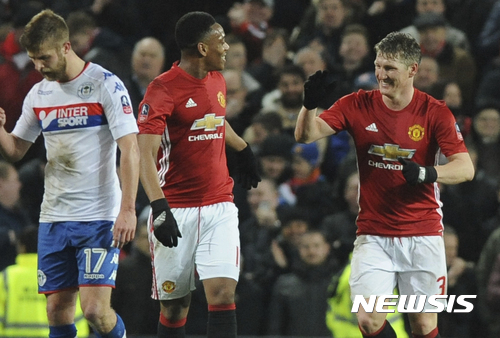 Manchester United's Bastin Schweinsteiger, right, celebrates with team mate Anthony Martial after scoring during the English FA Cup Fourth Round soccer match between Manchester United and Wigan Athletic at Old Trafford in Manchester, England, Sunday, Jan. 29, 2017. (AP Photo/Rui Vieira)