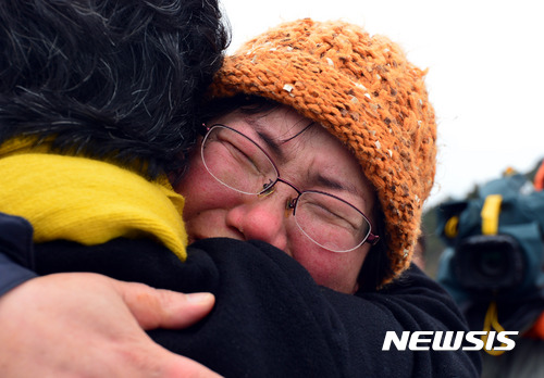 【진도=뉴시스】배동민 기자 = 3년 만에 물 위로 떠오른 세월호의 선적 현장을 지켜본 미수습자 가족들이 바다로 나간 지 나흘 만인 25일 오후 전남 진도군 팽목항으로 돌아왔다. 단원고 고(故) 조은화 학생의 어머니 이금희(49)씨가 눈물의 포옹을 하고 있다. 2017.03.25.   guggy@newsis.com