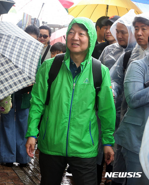 【서울=뉴시스】안철수 국민의당 대선후보가 5일 오전 부전시장에서 비옷을 입고 도보유세에 나서고 있다. 2017.05.05. (사진=안철수 캠프 제공) photo@newsis.com 