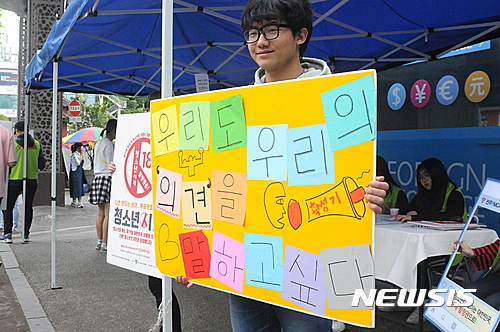 【전주=뉴시스】강인 기자 = 9일 전북 전주시 고사동 객사 앞에서 만 19세 미만 청소년을 위한 대선 모의투표가 진행되는 가운데 청소년 자원봉사자가 피켓을 들고 투표를 독려하고 있다. 2017.05.09.&nbsp; kir1231@newsis.com