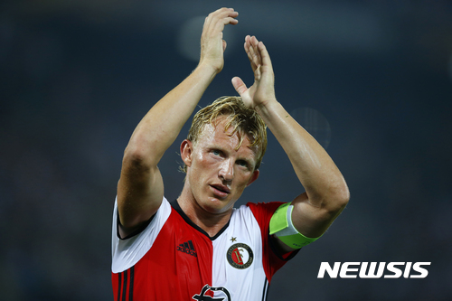 In this Sept. 15m 2016 file photo Feyenoord's team captain Dirk Kuyt applauds the supporters at the end of the Group A Europa League match between Feyenoord and Manchester United at the De Kuip stadium in Rotterdam, Netherlands. Veteran captain Dirk Kuyt scored a hat trick Sunday May 14, 2017, as Feyenoord beat Heracles Almelo 3-1 to win its 15th Dutch Eredivisie title and the first in 18 long years for its fervent fans. Kuyt returned to Feyenoord in the twilight of his career saying he wanted to lead the team to the Dutch championship and scored his 100th goal for the club in the first minute to settle nerves throughout Rotterdam. (AP Photo/Peter Dejong)