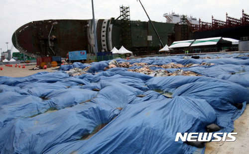 【목포=뉴시스】신대희 기자 = 세월호 선내 수색 28일째인 16일 오후 전남 목포시 목포신항만에 육상 거치된 세월호 선체에서 나온 펄들이 쌓여 있다. 2017.05.16.   sdhdream@newsis.com