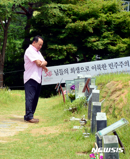 【광주=뉴시스】배동민 기자 = 고 이한열 열사의 30주기를 하루 앞둔 8일 오전 광주 북구 망월동 민족민주열사 묘역(5·18 옛묘역)의 이한열 열사 묘소 앞에서 백신종(65)씨가 추모의 시간을 갖고 있다. 이한열 열사 아버지와 친분이 있는 백씨는 1987년부터 매년 묘소를 찾고 있다. 2017.06.08. guggy@newsis.com