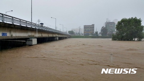 【청주=뉴시스】김재광 기자 = 16일 내린 집중호우에 충북 청주시 서원구 사직동 무심천을 흐르는 흙탕물이 1운천교를 삼킬 듯 거세게 흐르고 있다. 2017.07.16. <a href="mailto:kipoi@newsis.com">kipoi@newsis.com</a> 