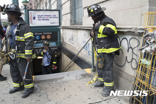 【뉴욕= AP/뉴시스】 = 올 6월 27일 뉴욕 지하철의 탈선사고가 발생한 시내 할렘 지하철 역에서 구급대원들이 구조작업을 하고 있다.  뉴욕지하철은 연착, 고장, 탈선사고가 끊이지 않아 대대적인 보수가 필요한 상태이며, 앞으로 안내 방송에서 남녀 구분 용어가 사라지는 등 소통과 설비 면에서 개혁에 나서고 있다.     